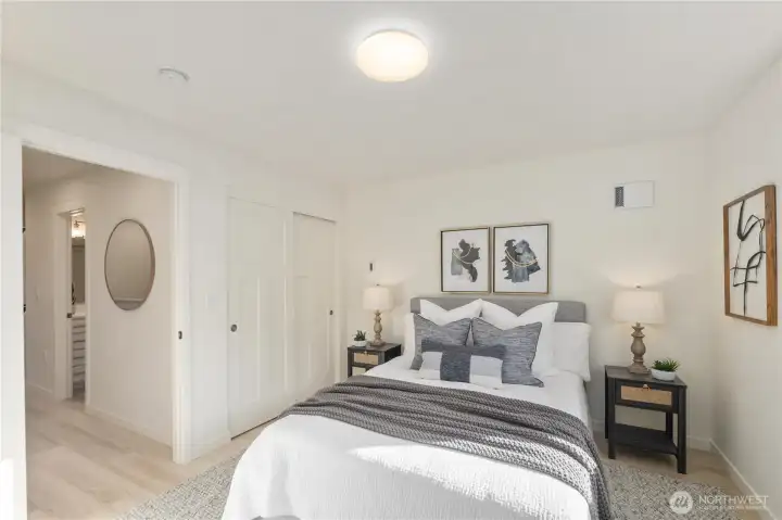 Spacious bedroom layout with neutral tones, closet storage, and access to nearby full bathroom.
