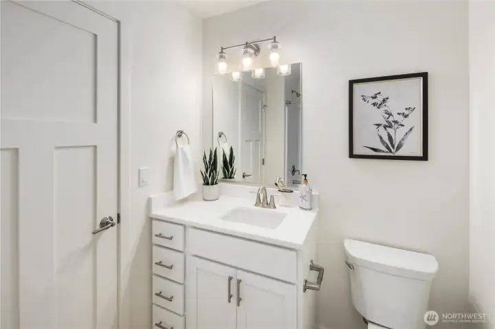Upper-level full bathroom with contemporary vanity, modern lighting, and clean finishes designed for low-maintenance living on San Juan Island.