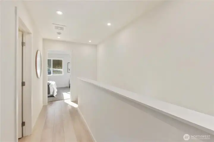 Functional upper-level hallway connecting bedrooms, bath, and laundry with ease.