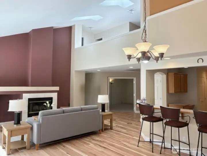 Living room also enjoys the beautiful floors and high vault ceilings. Loft area above with two skylights. - virtually staged.