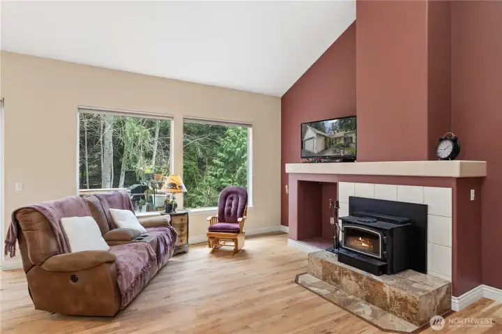 Wood Burning Fireplace and a second story vaulted ceiling amplify the forrest