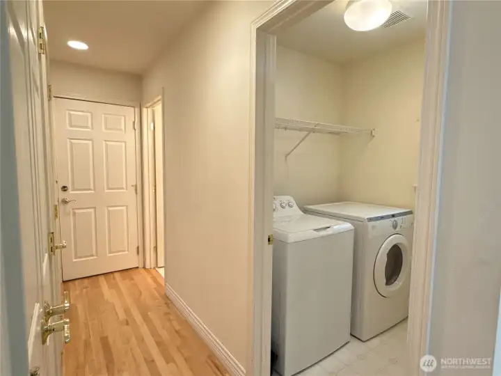 Hallway connecting the garage, guest half bath, pantry and laundry room to the kitchen area.