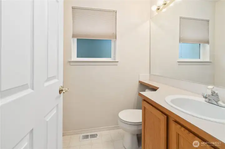 Half bathroom for guest is conveniently located between near the garage, entry and kitchen