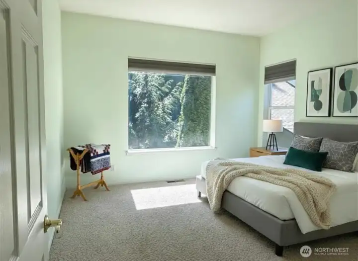 Primary Bedroom on the main floor with lovely picture window - virtually staged.