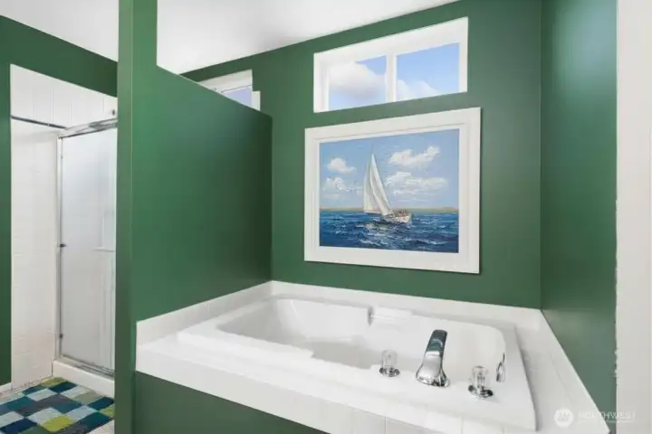 Garden tub and shower have windows that are high for natural light - virtually staged