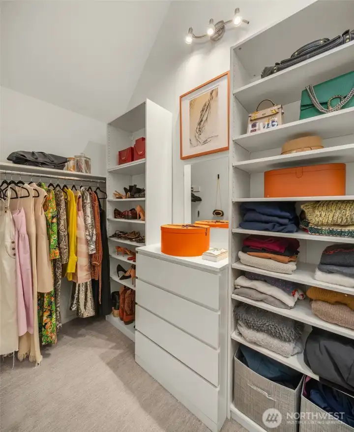 One of several primary suite closets, this walk-in features vaulted ceilings and natural light. One of several primary suite closets, this walk-in features vaulted ceilings and natural light.