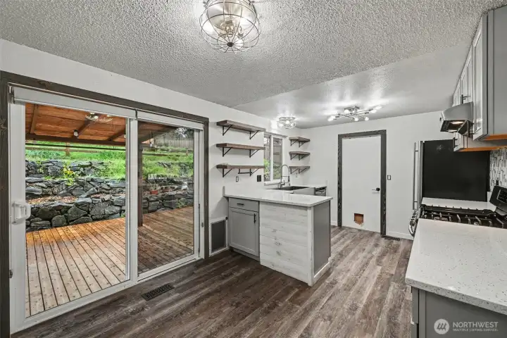 Beautifully renovated kitchen with quartz countertops and new cabinets