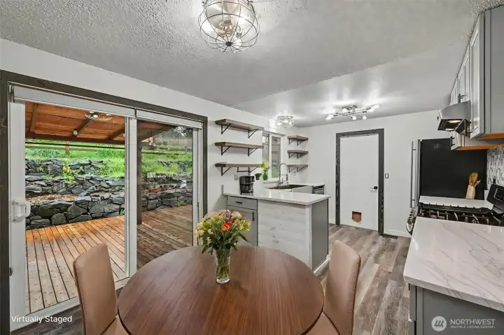 Eating area with access to the backyard. Virtually staged