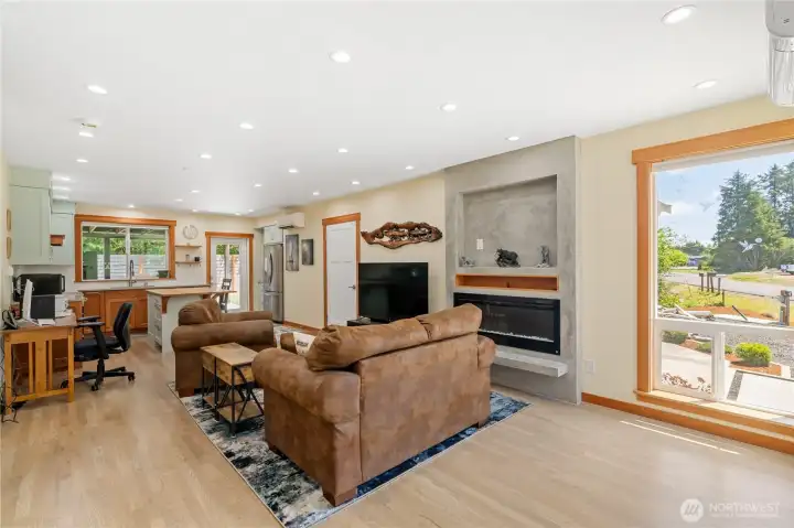 Living room with floor to ceiling windows & electric fireplace