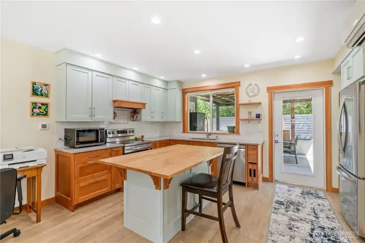 Kitchen with island for seating, door to patio