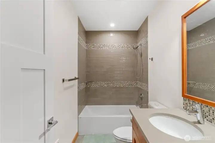 Shared hallway bath with tile surround
