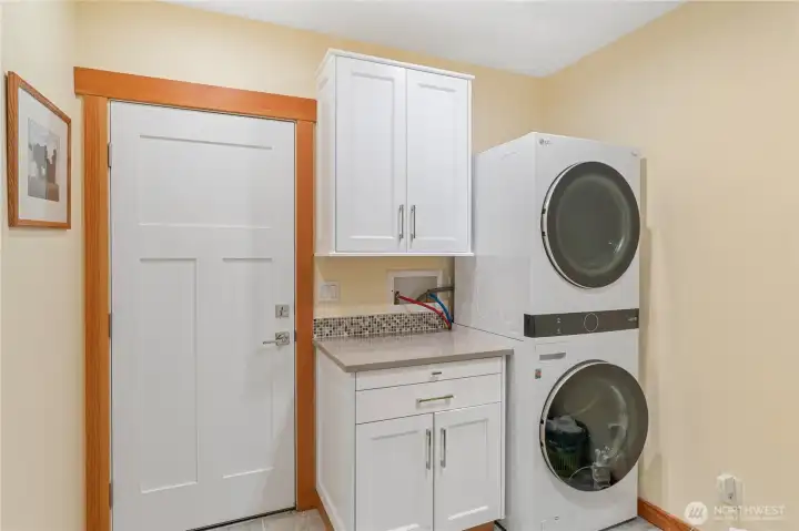 Large laundry room with door to outside