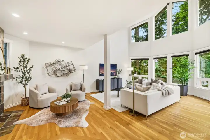 Filled with natural light, the thoughtfully designed floor plan showcases a soaring ceiling in the living room, expansive windows, rich hardwood flooring, and elegant living spaces.