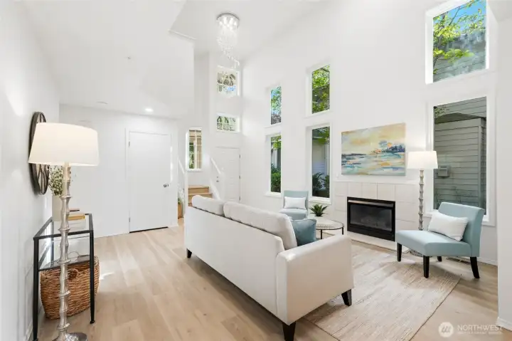 Vaulted living room centered around a cozy gas fireplace.