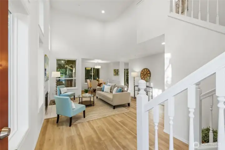 Soaring two-story ceilings and abundant natural light create an impressive first impression.
