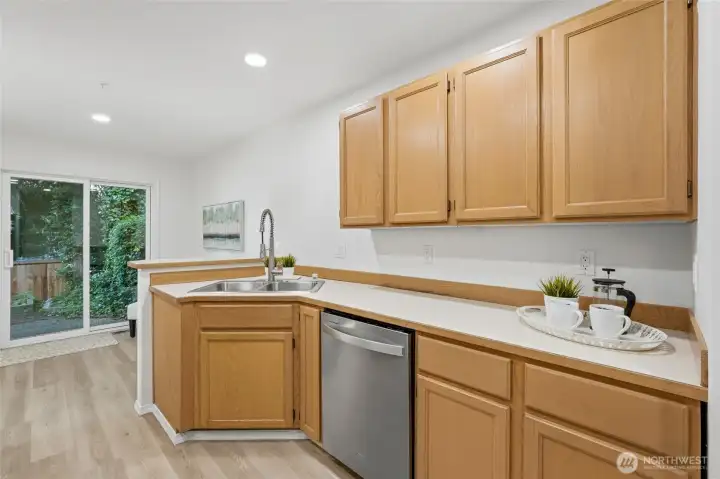 Bright kitchen overlooking the private backyard and patio.