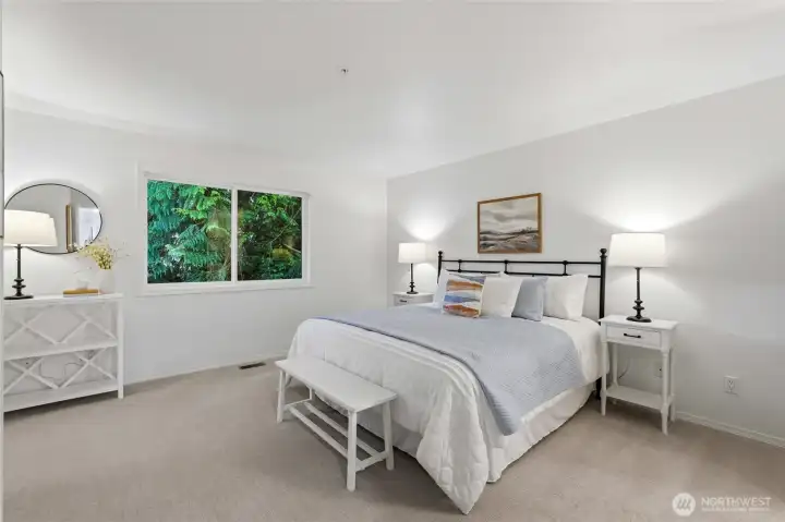 Spacious primary suite with large windows and peaceful outlook.