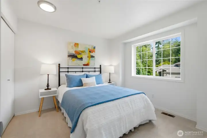 Large second bedroom with natural light and versatile use options.