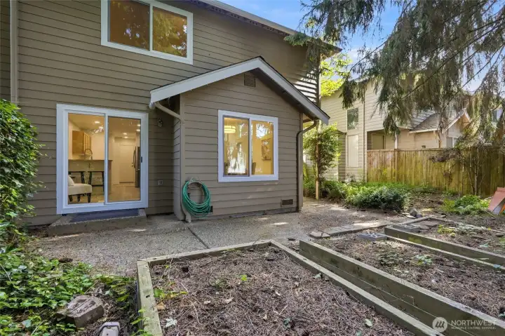 Private patio and backyard space surrounded by mature landscaping.
