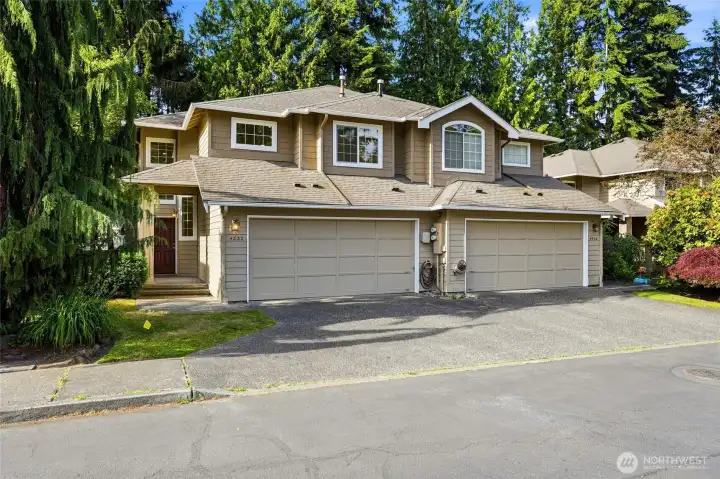 End-unit location with attached two-car garage and additional guest parking nearby.