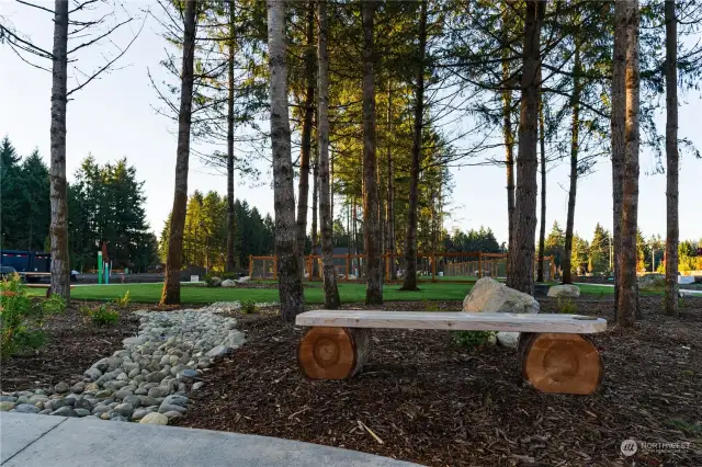 The neighborhood boasts a fenced Dog Park, providing a safe and designated area for residents' furry companions to play and socialize off-leash. Wooden benches found throughout the Park provide a tranquil place to relax and enjoy the serene surroundings.