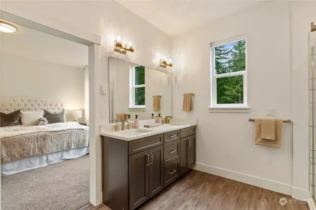 Prepare to be captivated by the dreamy Primary Bathroom! Revel in the expansive mirror, dual sink vanity boasting fabulous storage and stunning quartz counters. The touch of a dial directs warm air out from a vent below the vanity to keep your toes nice and toasty.