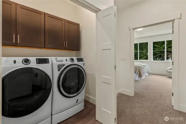 The Utility Room features ample cabinetry for storage, great counterspace for folding laundry and LVP flooring. W/D are INCLUDED.