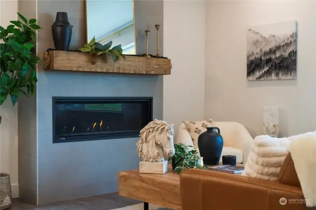 The stunning horizontal gas fireplace with floor to ceiling tile surround is definitely the "Star of the Show", bringing warmth and a contemporary feel to this space.