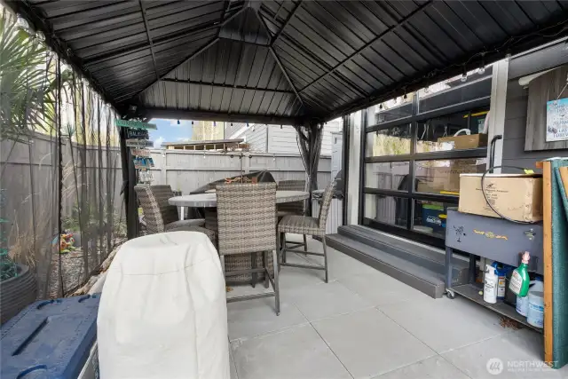 Gazebo with custom garage door for entertaining.  Gazebo stays.