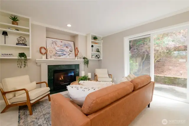 Large windows and a sliding glass door fill the space with natural light and provide easy access to the  Duradeck back deck—a low-maintenance outdoor area ideal for morning coffee, evening dining, or simply enjoying the peaceful surroundings. Slab ready and wired for a hot tub!