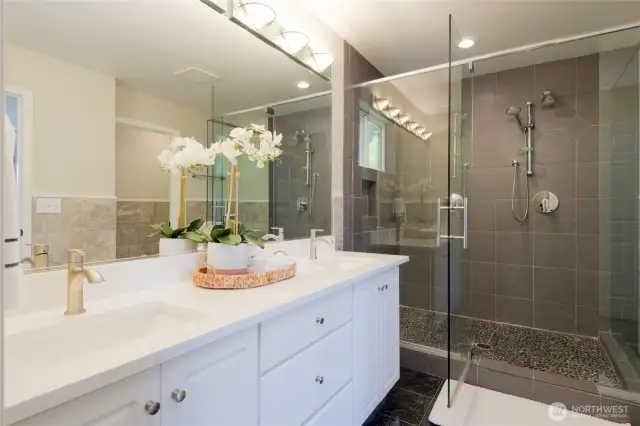 The luxurious en suite bath features dual-sink cabinetry, offering plenty of counter space and storage for effortless morning routines. A private water closet ensures added comfort and privacy, while the expansive double shower provides a spa-like experience with room to unwind.