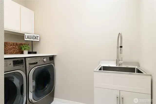 The laundry room is conveniently located on the same floor as the three main bedrooms. Particularly convenient with ample storage, utility sink and folding table. A skylight adds brings in cheery natural light!