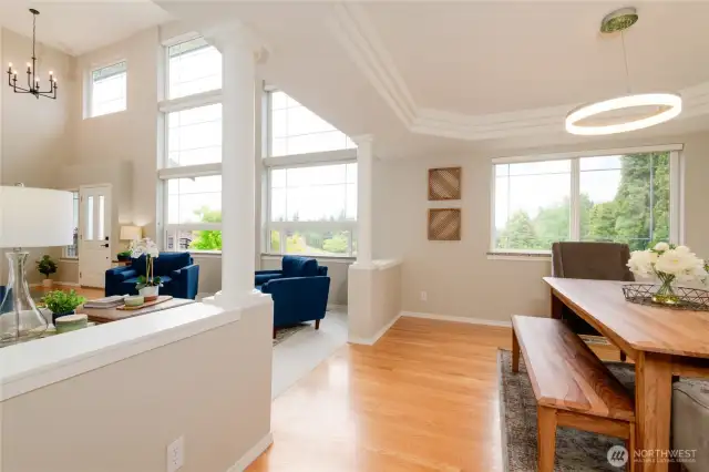 The dining room offers a perfect blend of drama and sophistication, designed to impress while maintaining a warm and inviting feel. Anchored by rich oak hardwood floors and framed by beautifully sculpted architectural details, this spacious area sets the stage for both grand entertaining and quiet at home meals.
