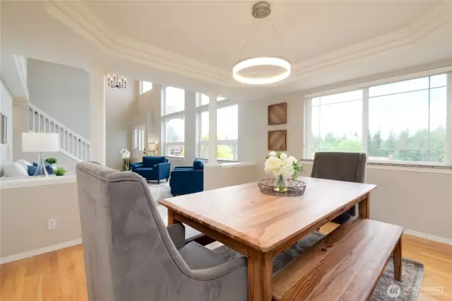 The beautifully crafted tray ceiling that adds a dramatic architectural touch. Natural light and classic design elements create a refined yet inviting space—perfect for both intimate dinners and stylish entertaining.
