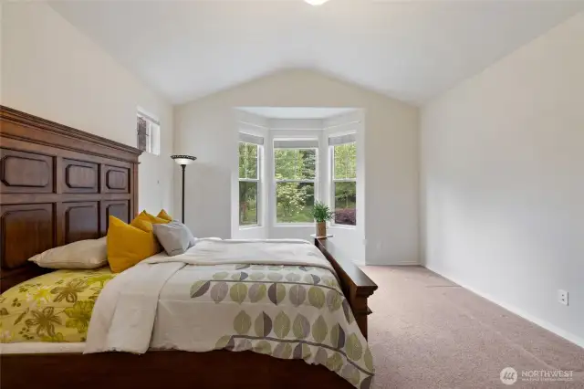 Primary Bedroom : Partially staged with real furniture/bedding. The bay windows are a gorgeous touch.