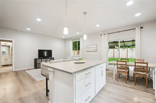 Dining space as well as eating area at kitchen island; note outlets are available on both sides of island