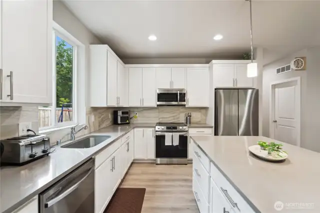 Amazing kitchen with quartz countertops, extra high cabinets, soft-close cupboards and drawers, and smart appliances.