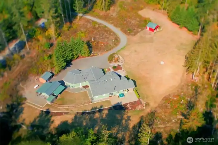 Sprawling rambler with 3 bdrms, 2.5 baths + den/office. Heated workshop space, barn w/hay storage, carports, dog run, fully fenced back yard, wood shed, storage shed, exansive patio and hot tub too!