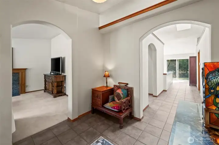 The light and bright entryway features a one of a kind tile inlay. High ceilings and architectural details lend character to the space.