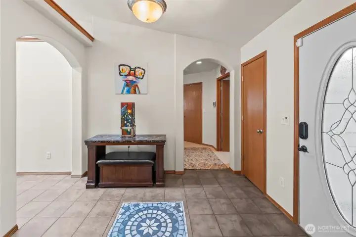 One of a kind tile inlay in the light and bright entryway, plus high ceilings and architectural details lend character to the space.
