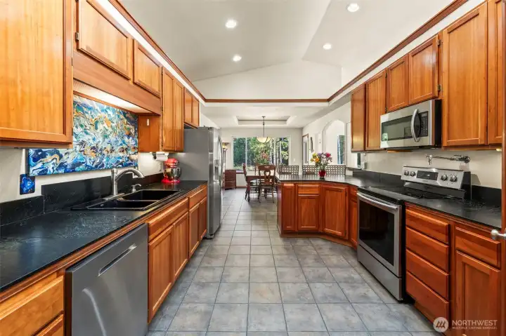 The kitchen boasts Italian tile floors, soapstone counters, high ceilings, skylights and is a wonderfully bright space.