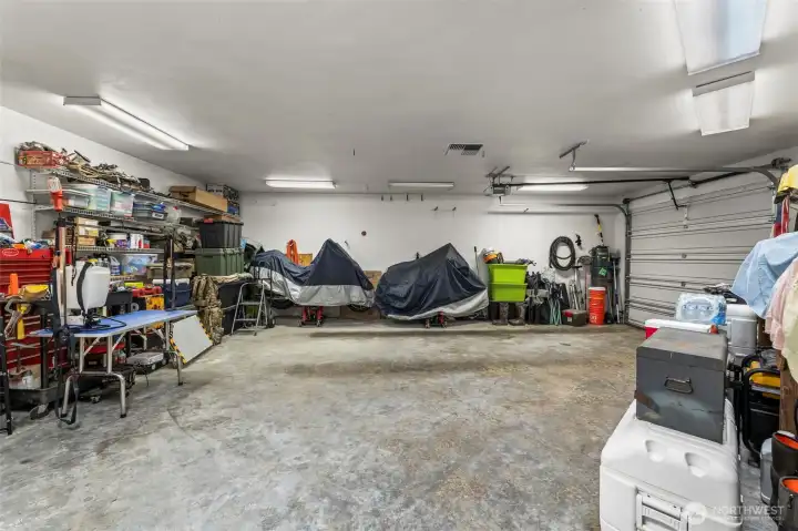 One of a kind 3 car garage with the end bay being fully isolated and insulated with it's own thermostatically controlled forced air heat and a half bath!