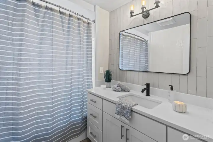 Second full bath off of Jr. bedrooms. Notice the beautiful tile work.