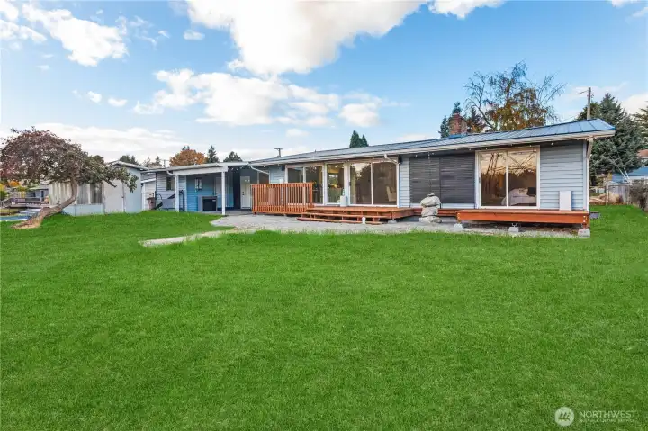 Rear view of home, grass edited to show potential