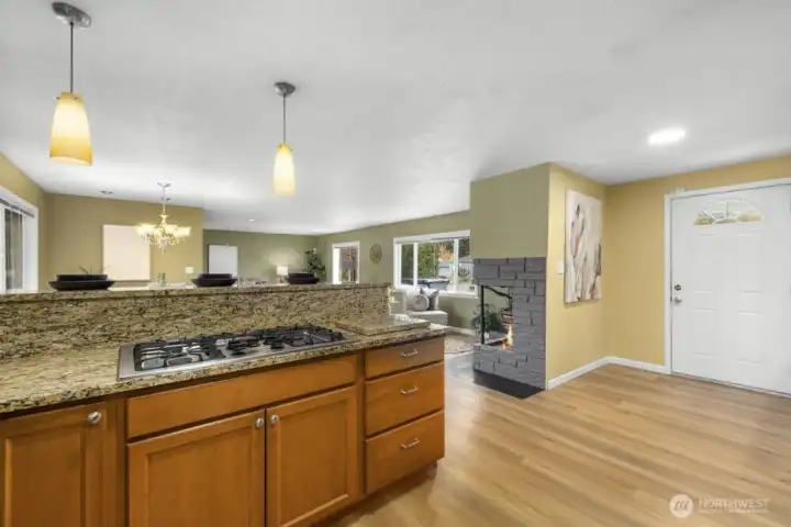 From the kitchen looking to the front door and the fireplace.