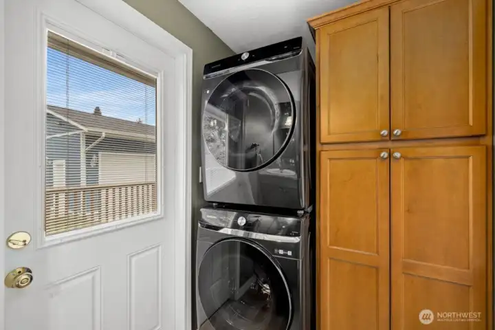 The half bathroom has a standing washer, dryer unit (replaced in 2022) and a large closet for linens or extra kitchen supplies.
