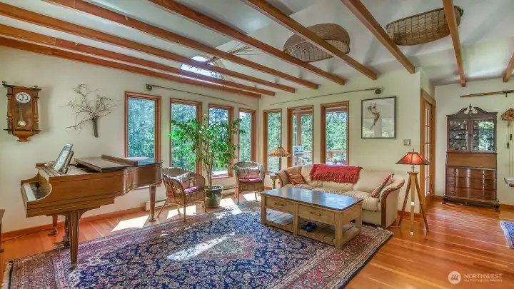 Open ceiling, fir floors and lots of light grace the living room.