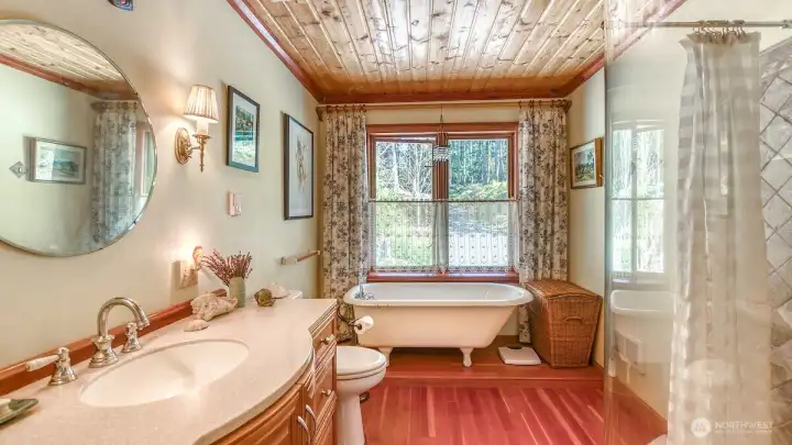 Main level full bath with separate claw foot tub and shower.