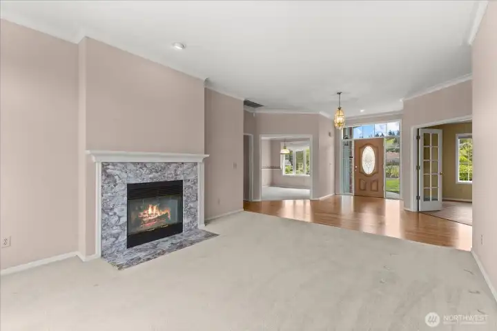 Living room facing formal dining, office and entry