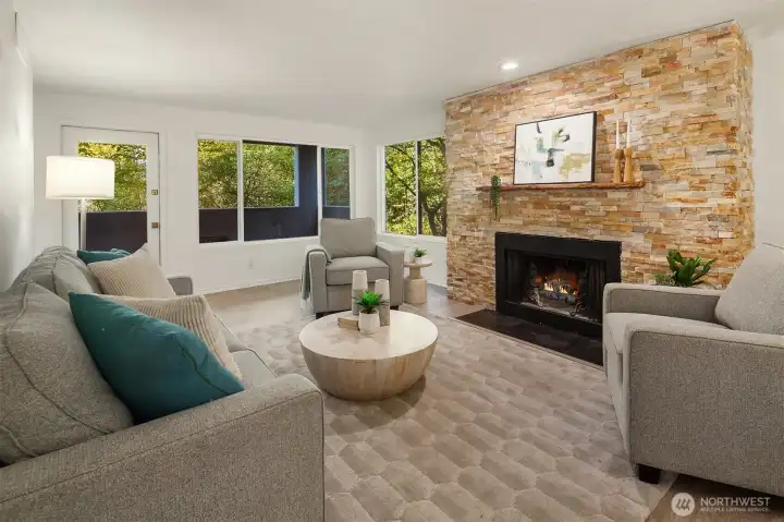 The living room with welcoming fireplace (fire added for effect, buyer to verify functionality) and seamless connection to covered deck.